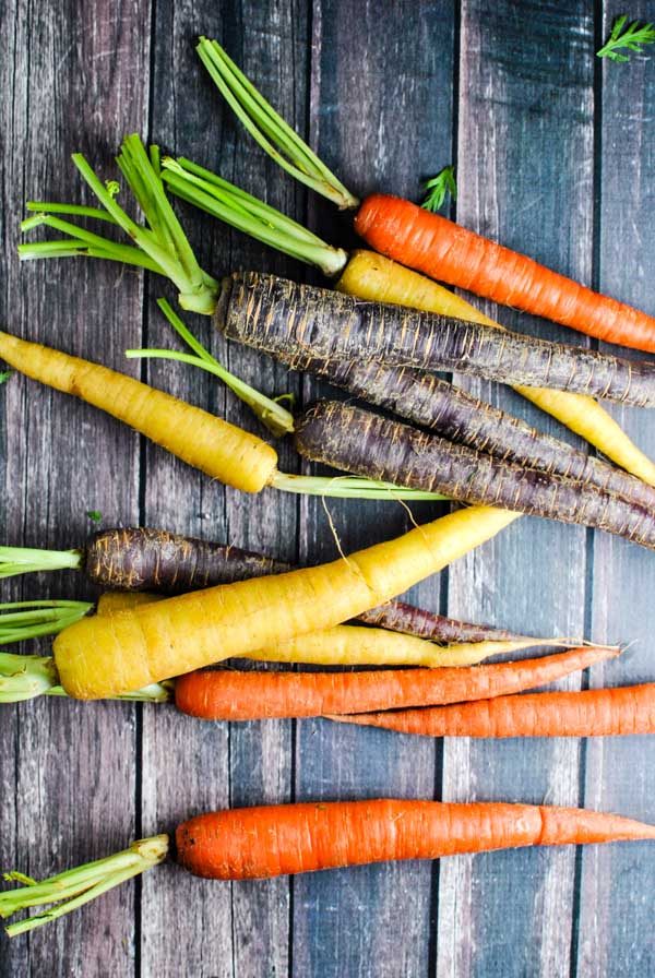 a quick and easy whole30 side recipe! whole30 roasted rainbow carrots! we love them because they get a little bit sweet and caramel-y and perrrrrfect :) | thepikeplacekitchen.com